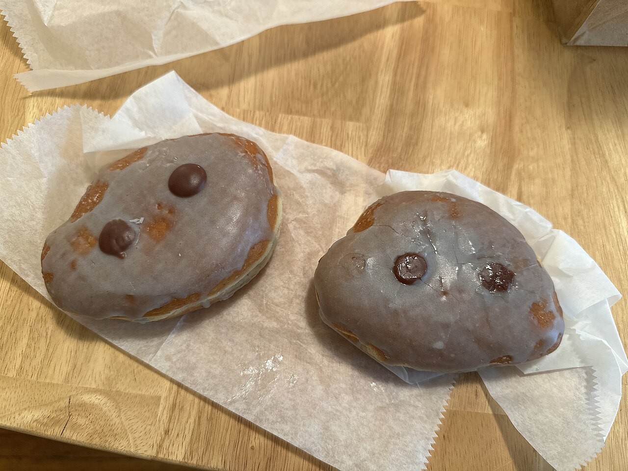 Mango donuts decorated to resemble Moo Deng, the pygmy hippopotamus.